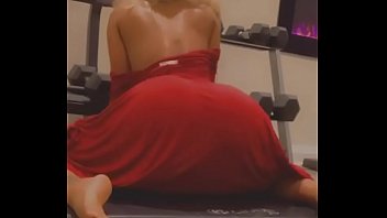 Stripper seductively shakes ass in red dress